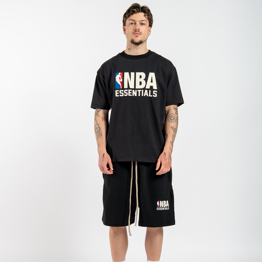 Model wearing a Fear of God Essentials NBA tee and shorts set