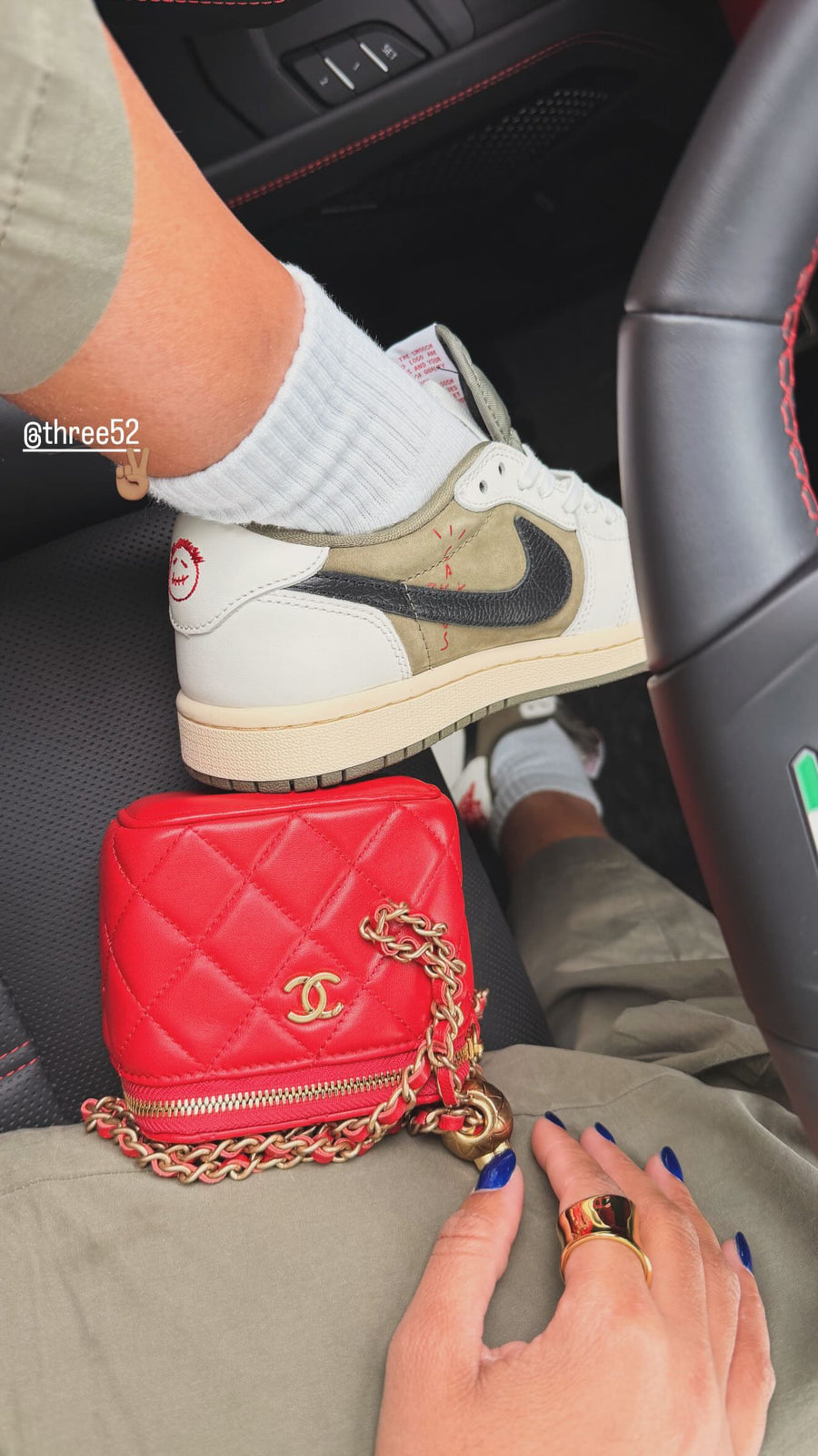 A Three52 customer wearing the Travis Scott Air Jordan 1 Low in a car