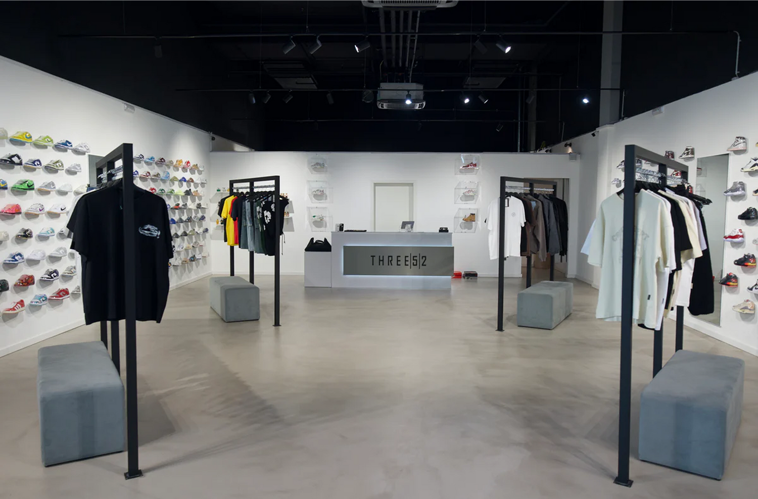 Inside the Three52 store at Cloche d'Or — sneaker wall displays and apparel racks around the THREE52 counter